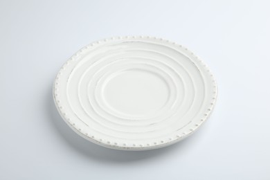 One empty ceramic plate isolated on white