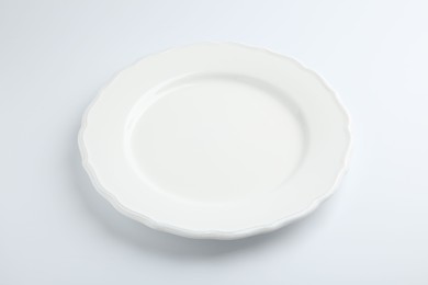 Photo of One empty ceramic plate isolated on white