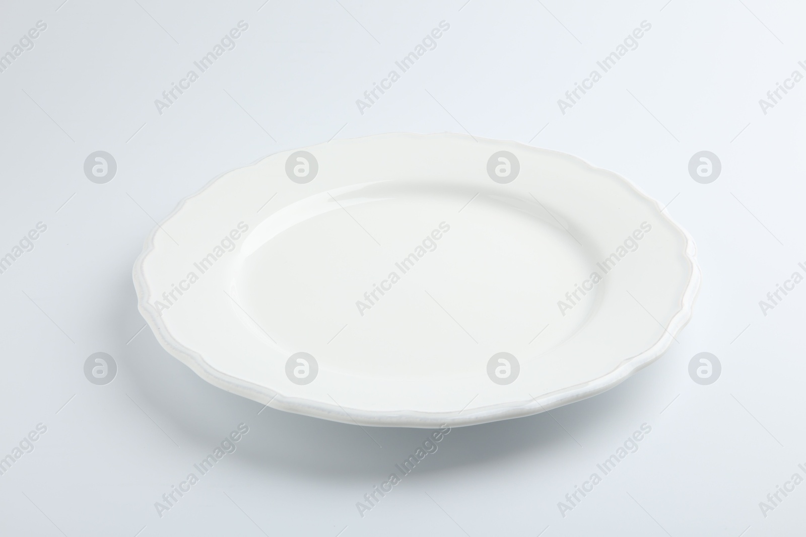 Photo of One empty ceramic plate isolated on white