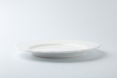 Photo of One empty ceramic plate isolated on white