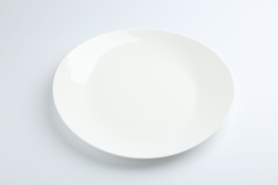 Photo of One empty ceramic plate isolated on white