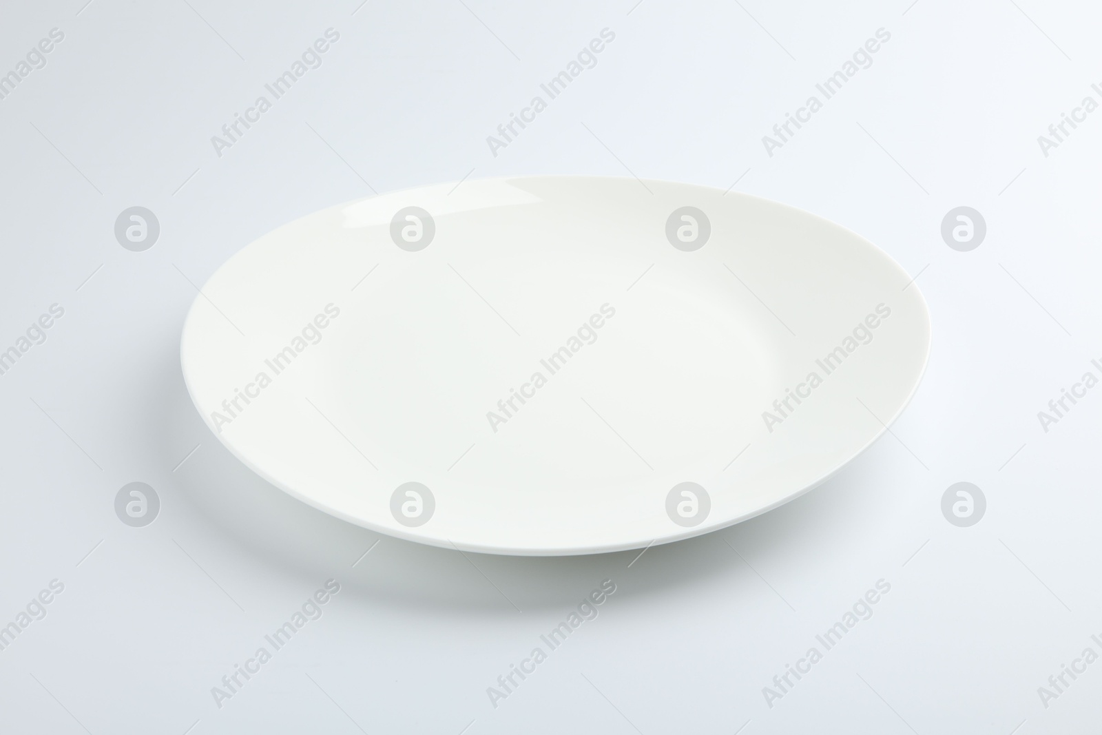 Photo of One empty ceramic plate isolated on white