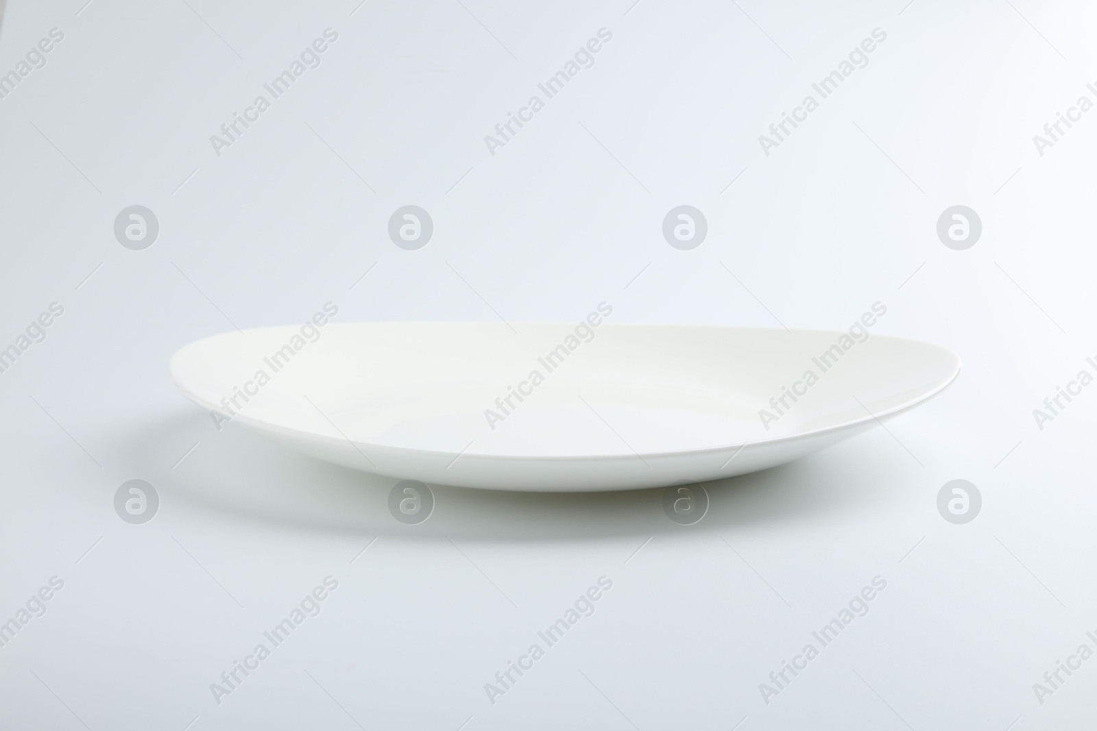 Photo of One empty ceramic plate isolated on white