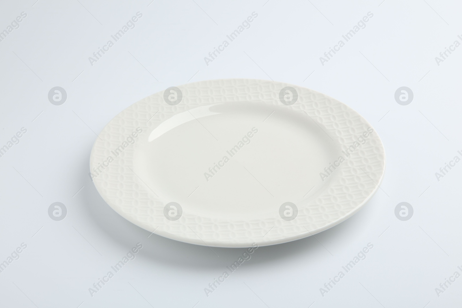 Photo of One empty ceramic plate isolated on white