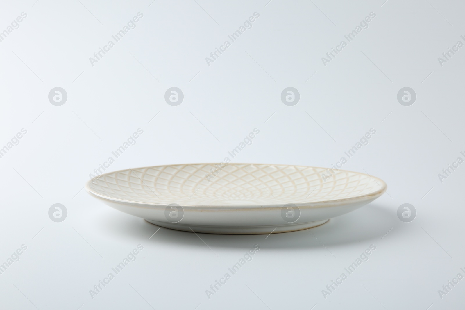 Photo of One empty ceramic plate isolated on white