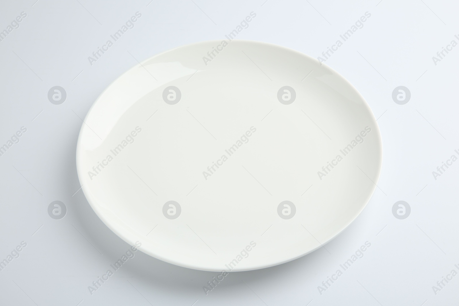 Photo of One empty ceramic plate isolated on white