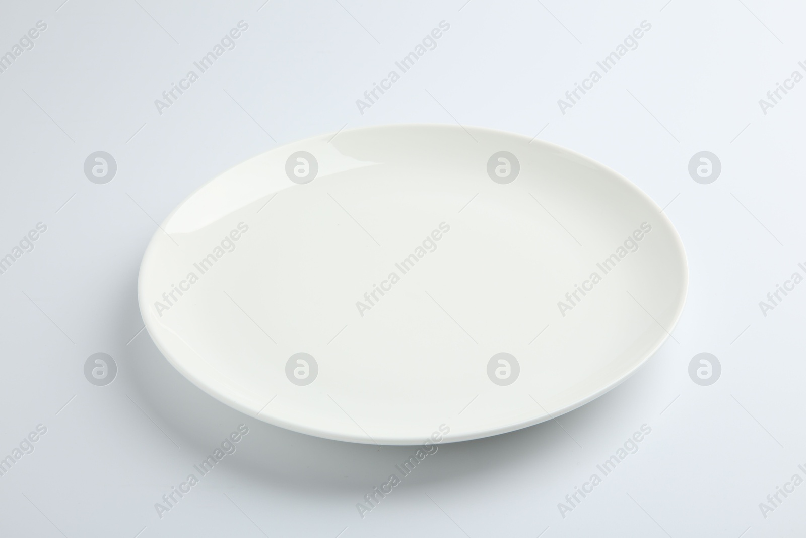 Photo of One empty ceramic plate isolated on white