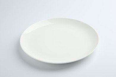 Photo of One empty ceramic plate isolated on white