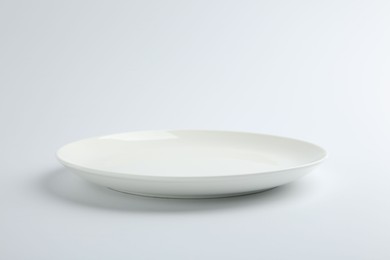 Photo of One empty ceramic plate isolated on white