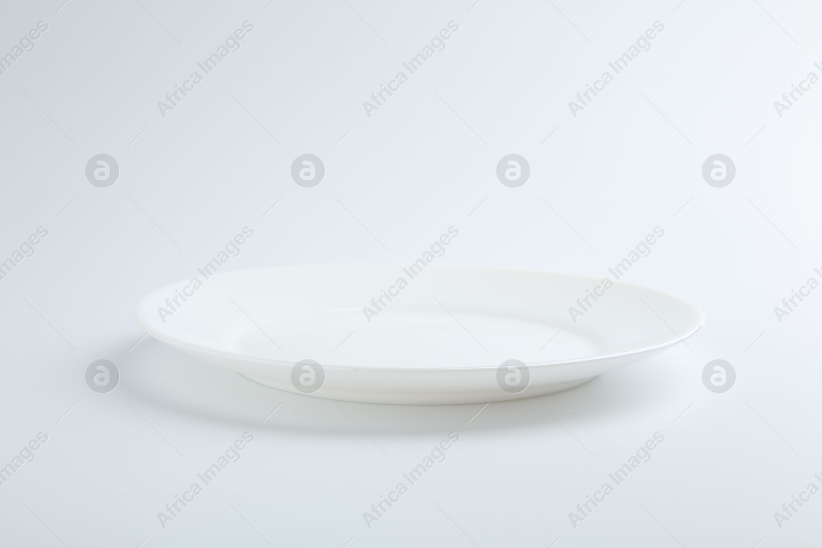 Photo of One empty ceramic plate isolated on white