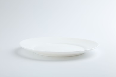 Photo of One empty ceramic plate isolated on white