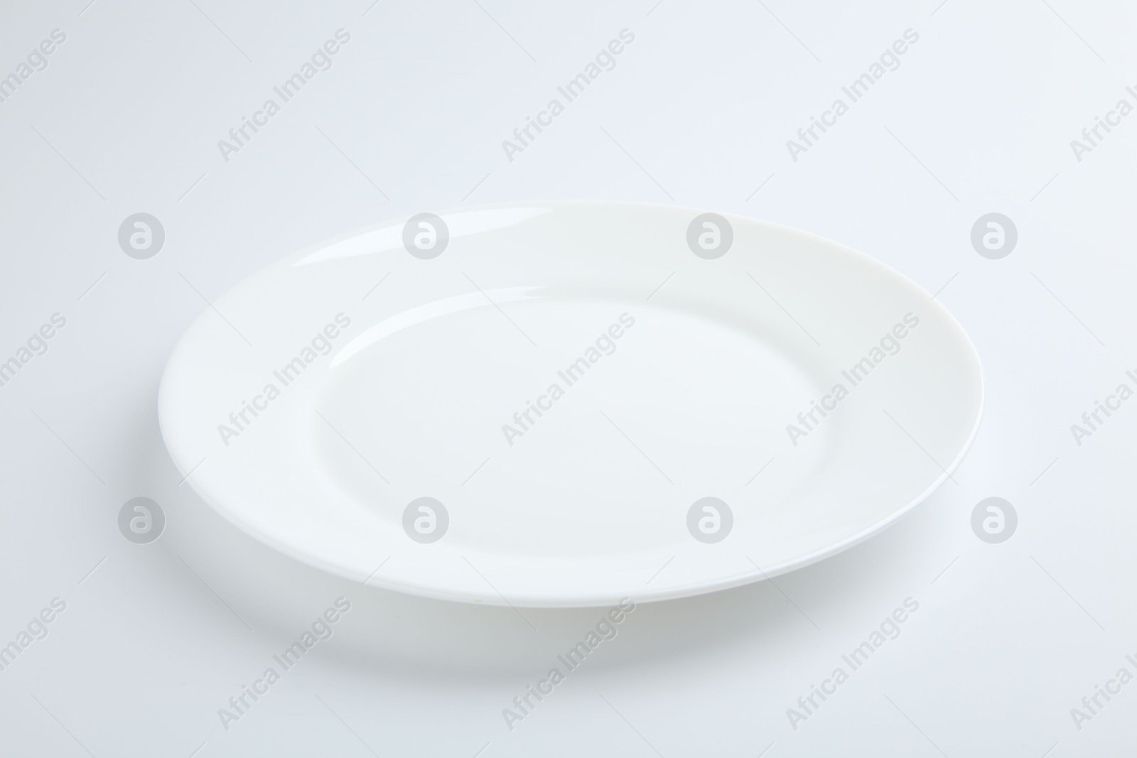 Photo of One empty ceramic plate isolated on white