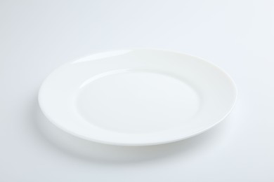 Photo of One empty ceramic plate isolated on white