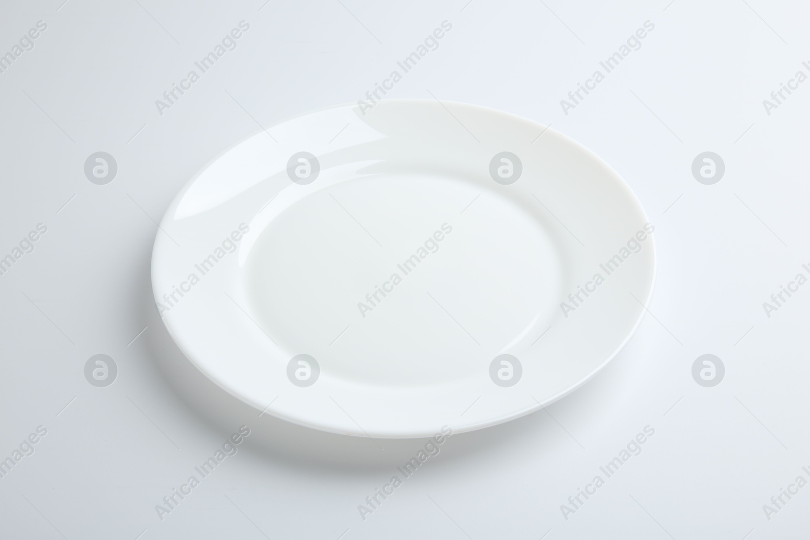 Photo of One empty ceramic plate isolated on white