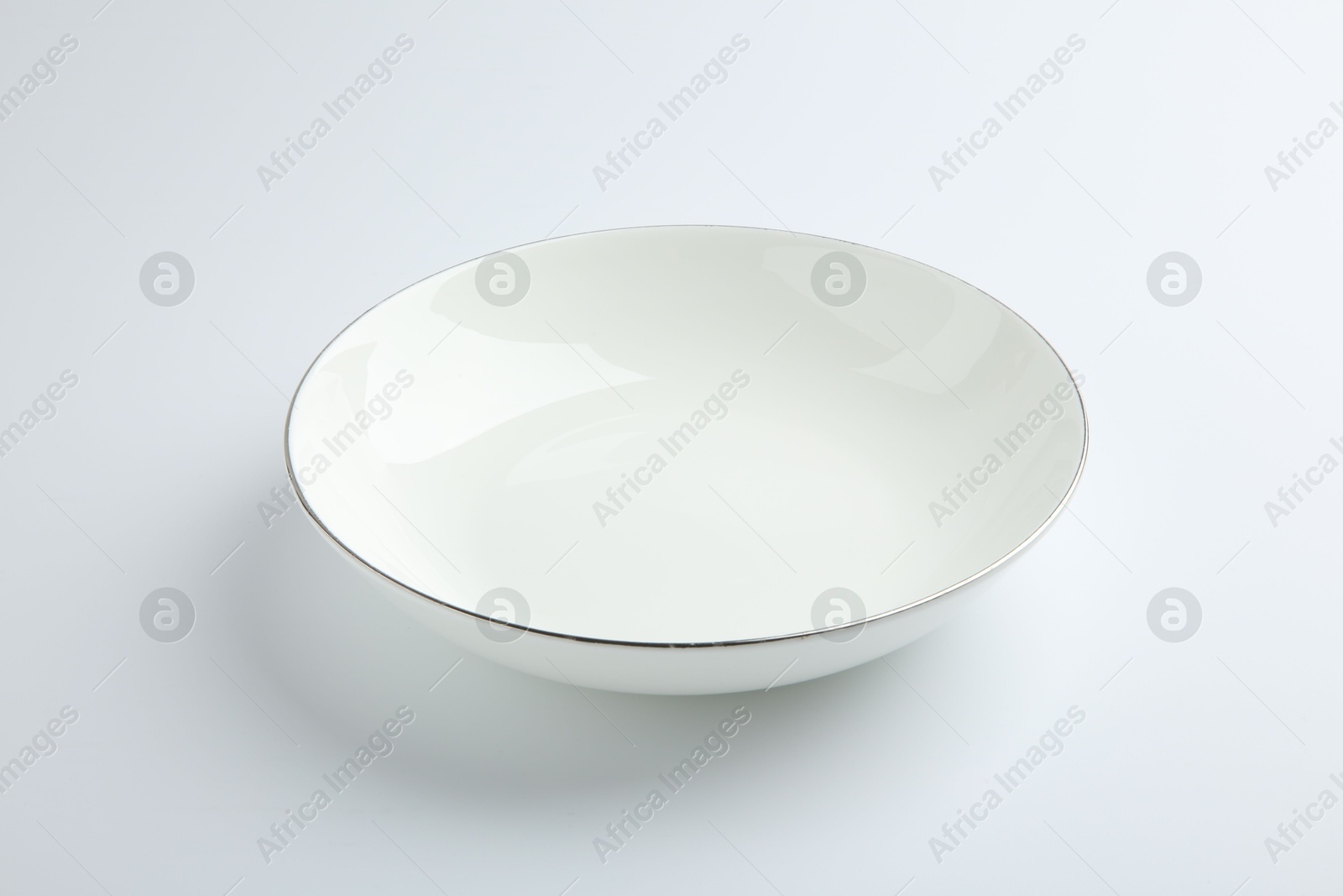 Photo of One empty ceramic bowl isolated on white