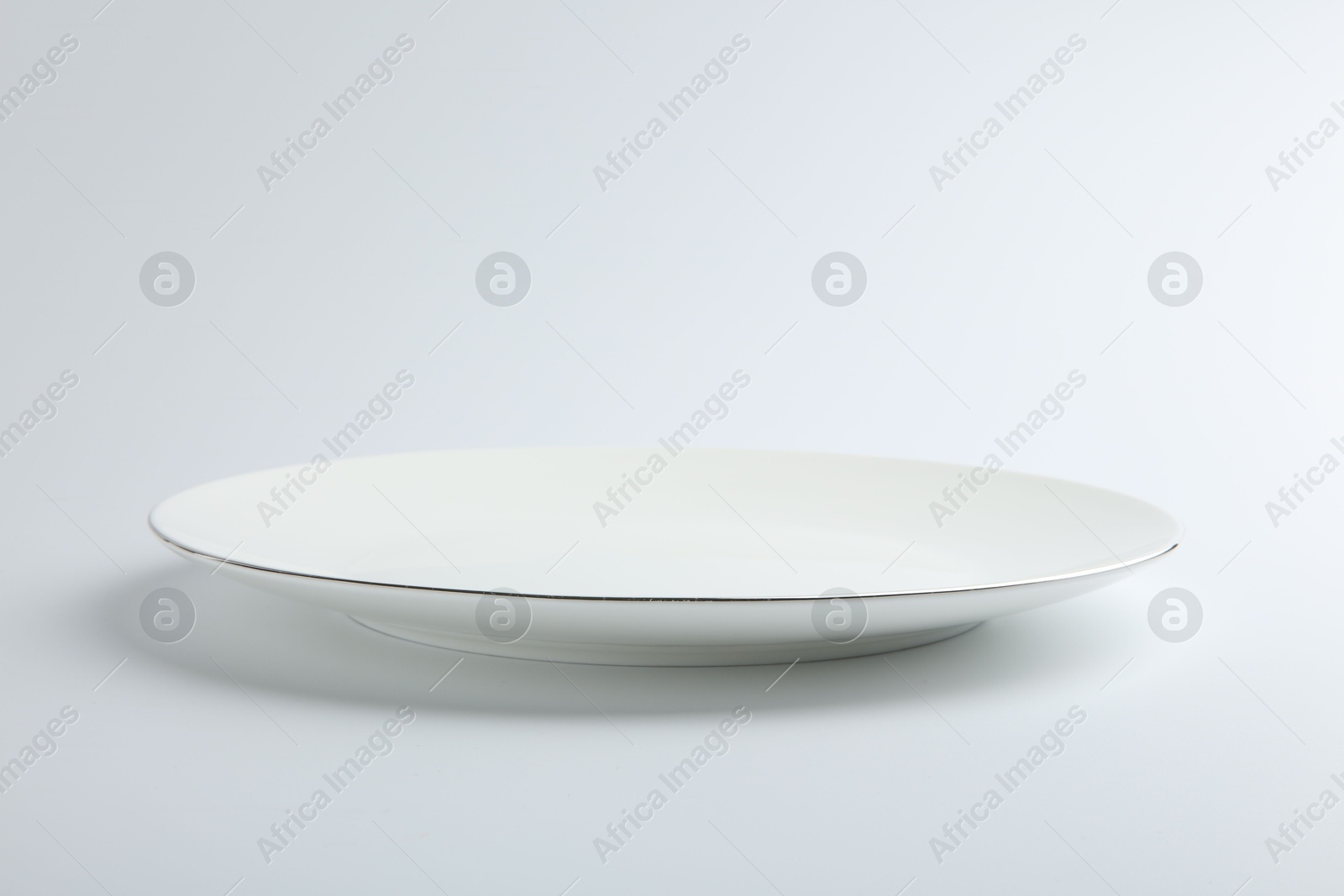 Photo of One empty ceramic plate isolated on white