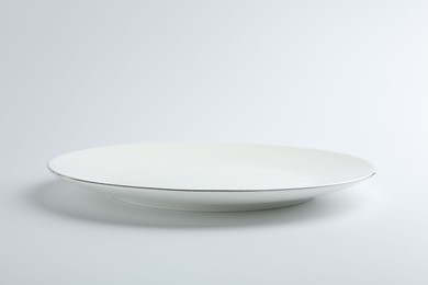 Photo of One empty ceramic plate isolated on white