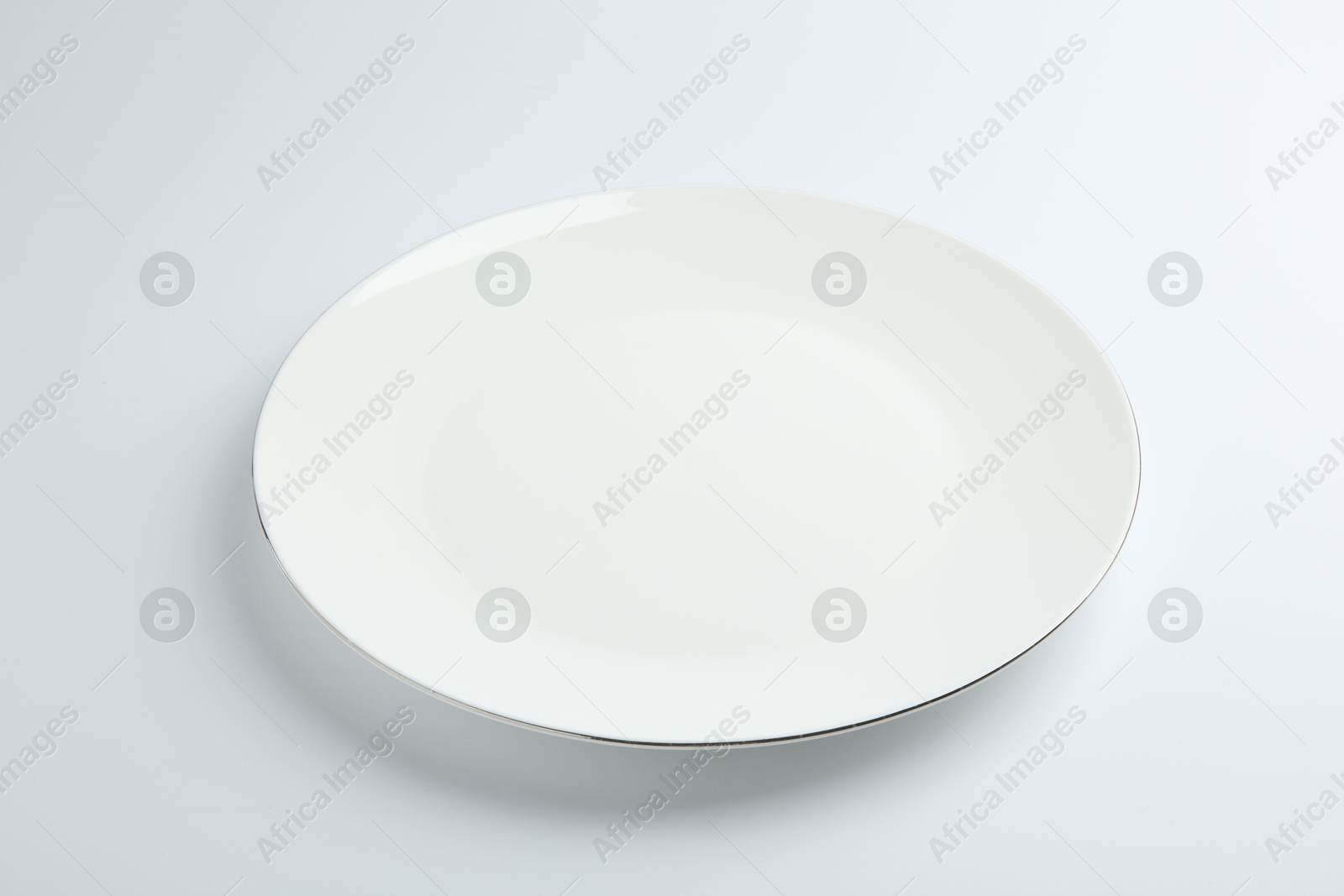 Photo of One empty ceramic plate isolated on white