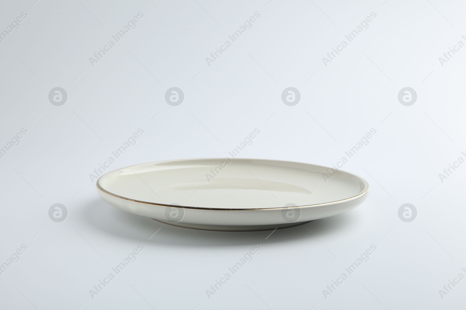 Photo of One empty ceramic plate isolated on white