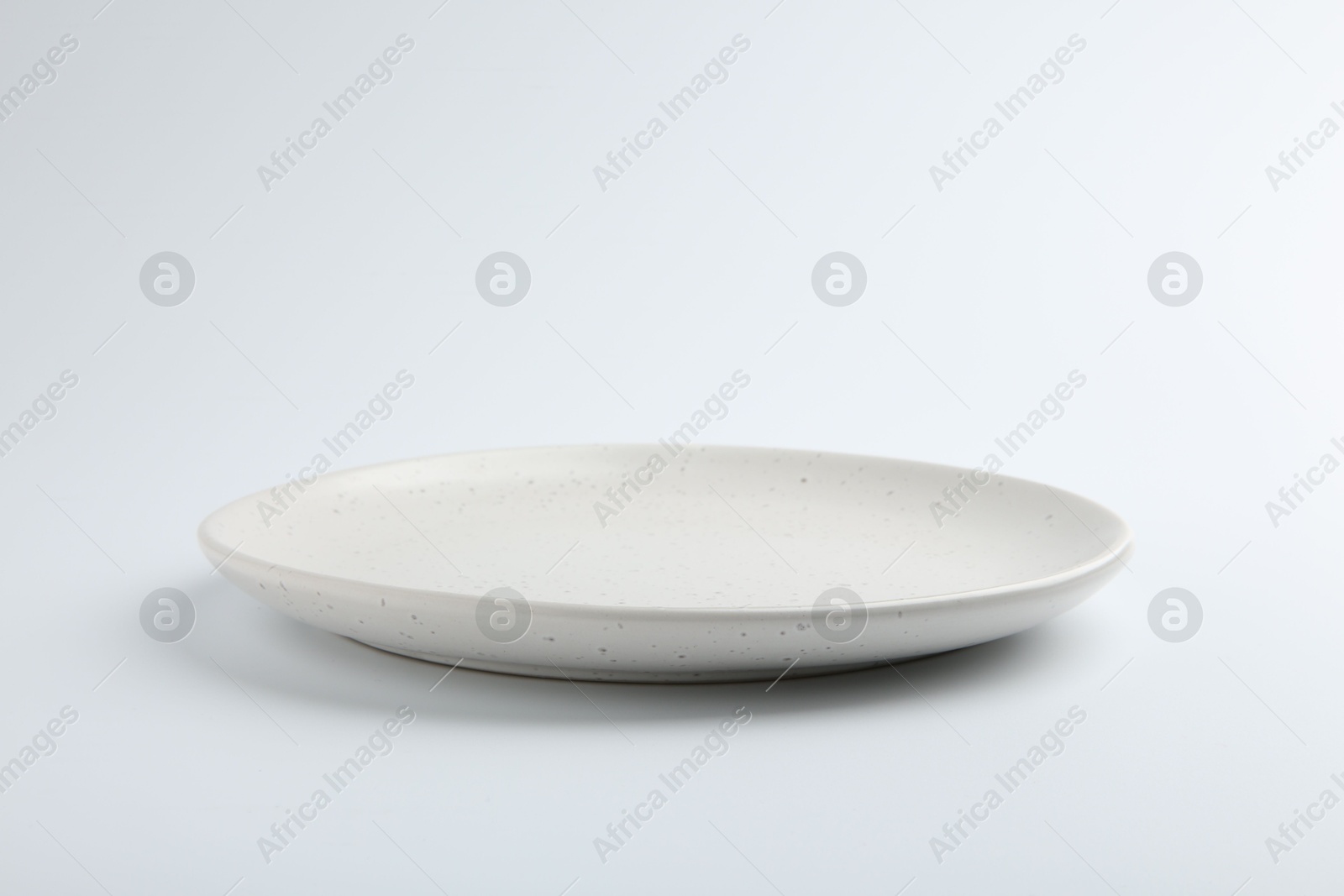 Photo of One empty ceramic plate isolated on white