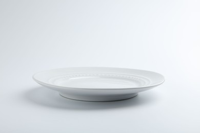 Photo of One empty ceramic plate isolated on white