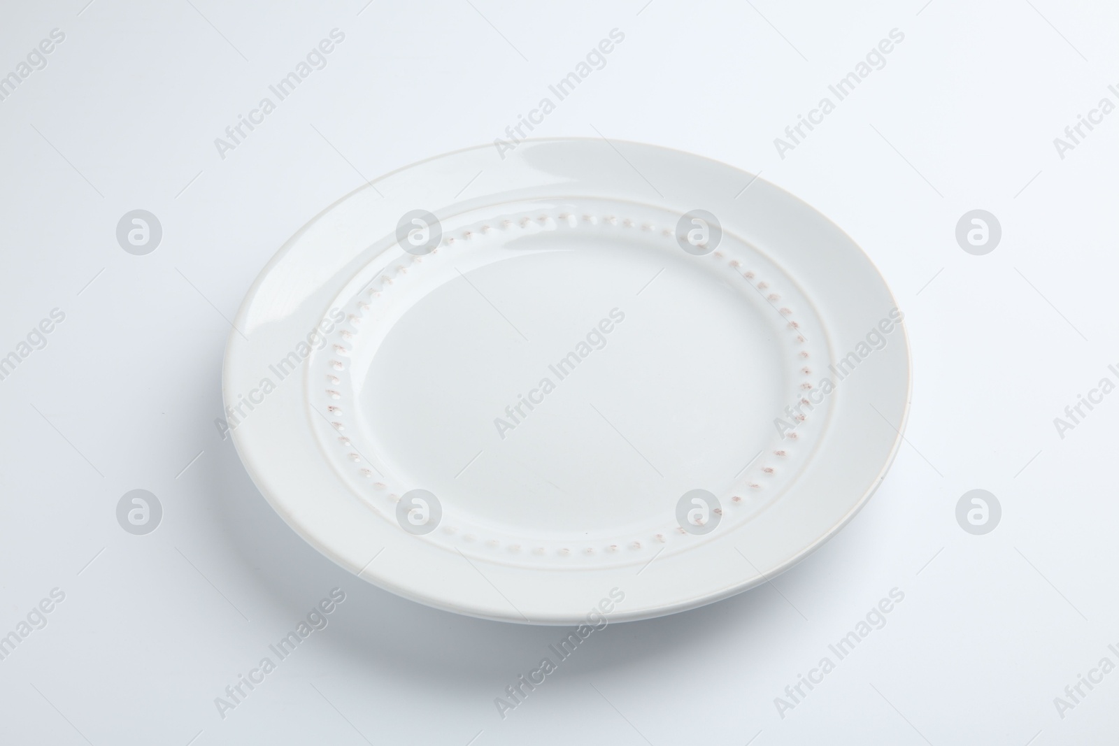 Photo of One empty ceramic plate isolated on white