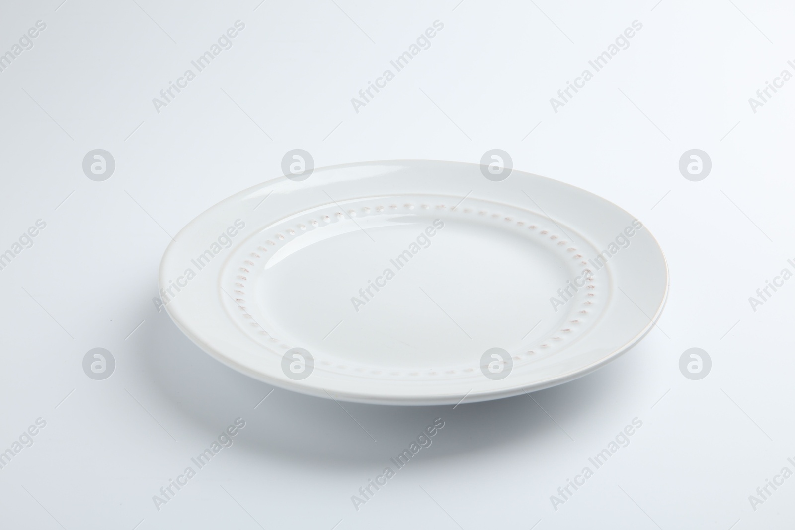 Photo of One empty ceramic plate isolated on white