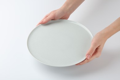 Photo of Woman with empty ceramic plate on white background, closeup