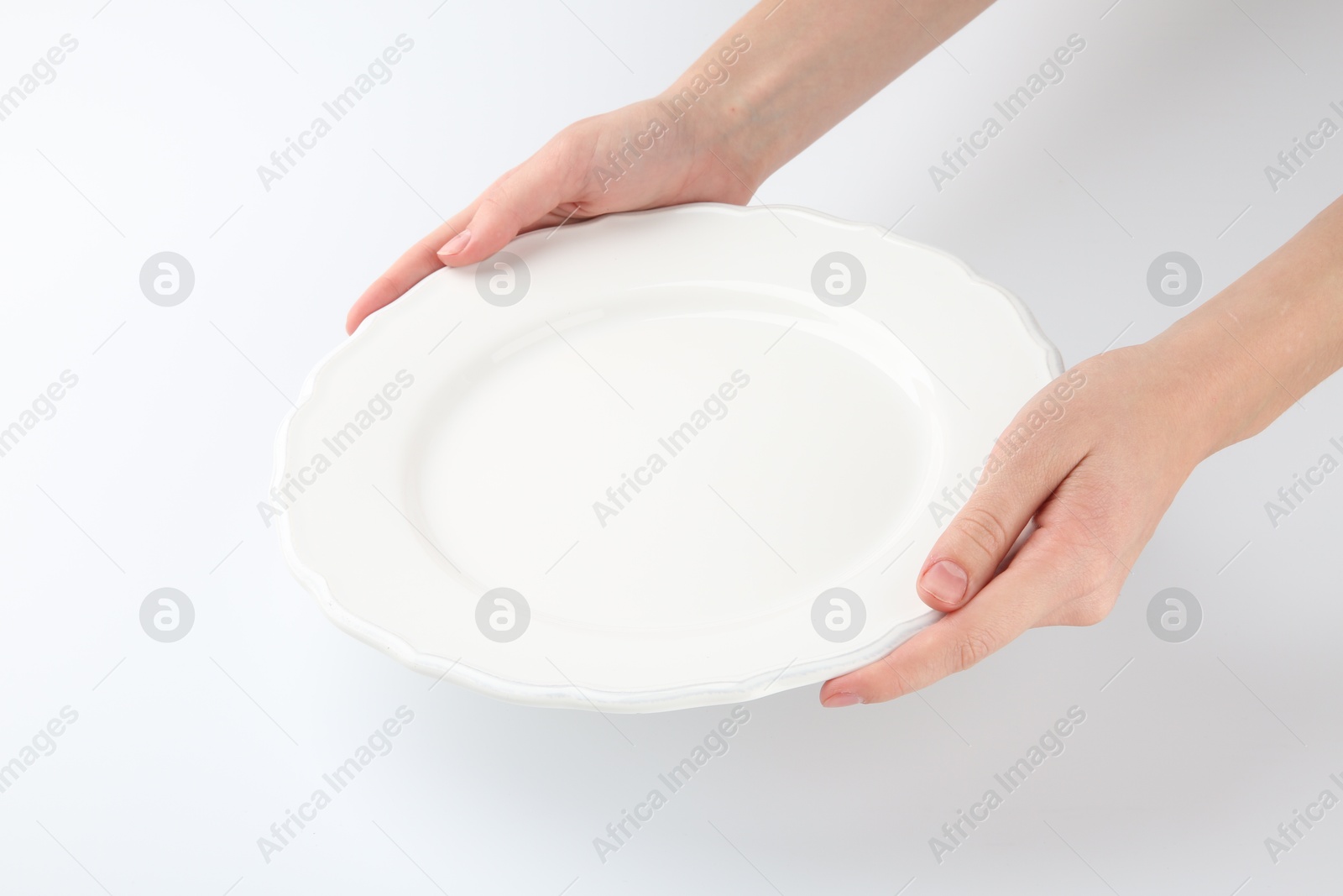 Photo of Woman with empty ceramic plate on white background, closeup