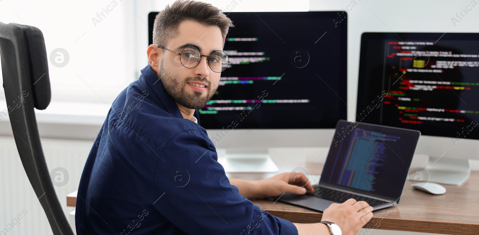 Image of Programmer working at desk in office. Banner design