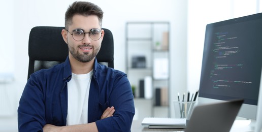 Image of Young programmer working in office. Banner design