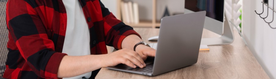 Image of Programmer working with laptop in office, closeup. Banner design