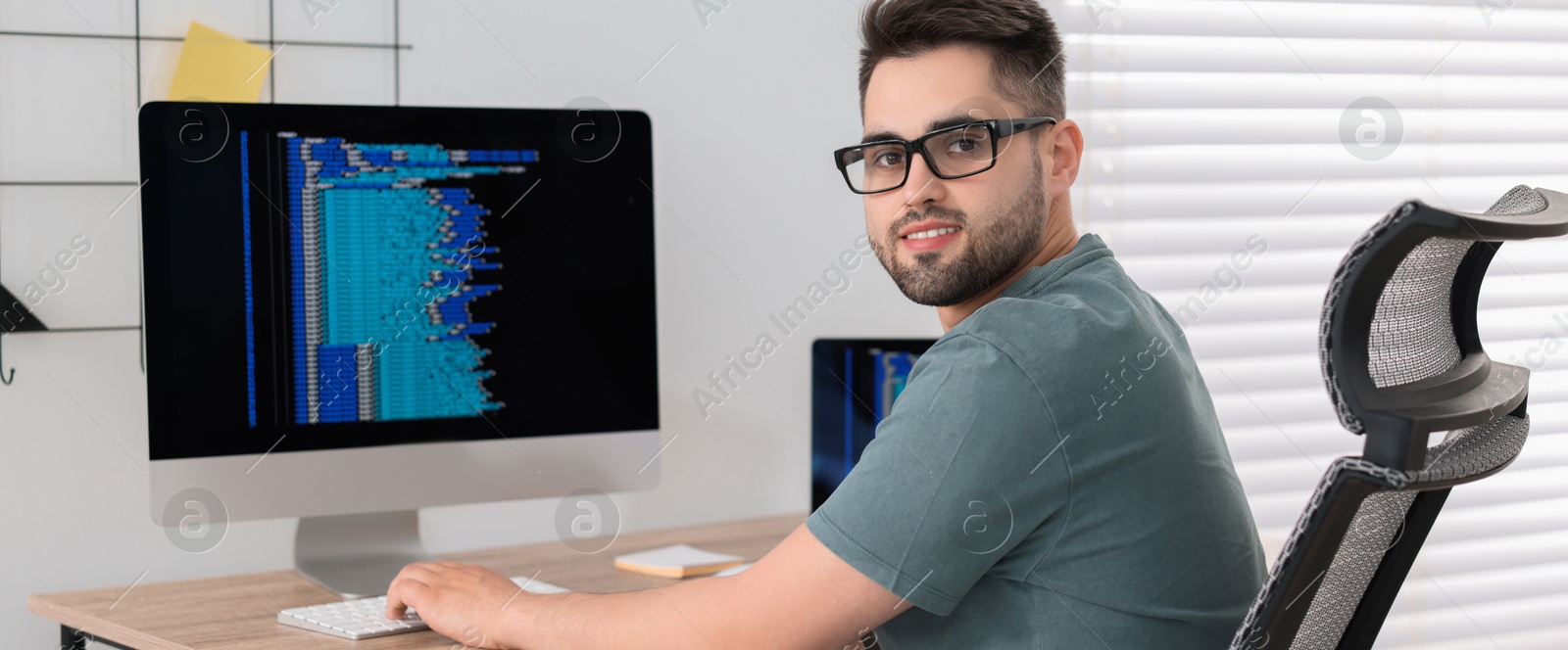 Image of Programmer working at desk in office. Banner design