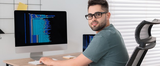 Programmer working at desk in office. Banner design