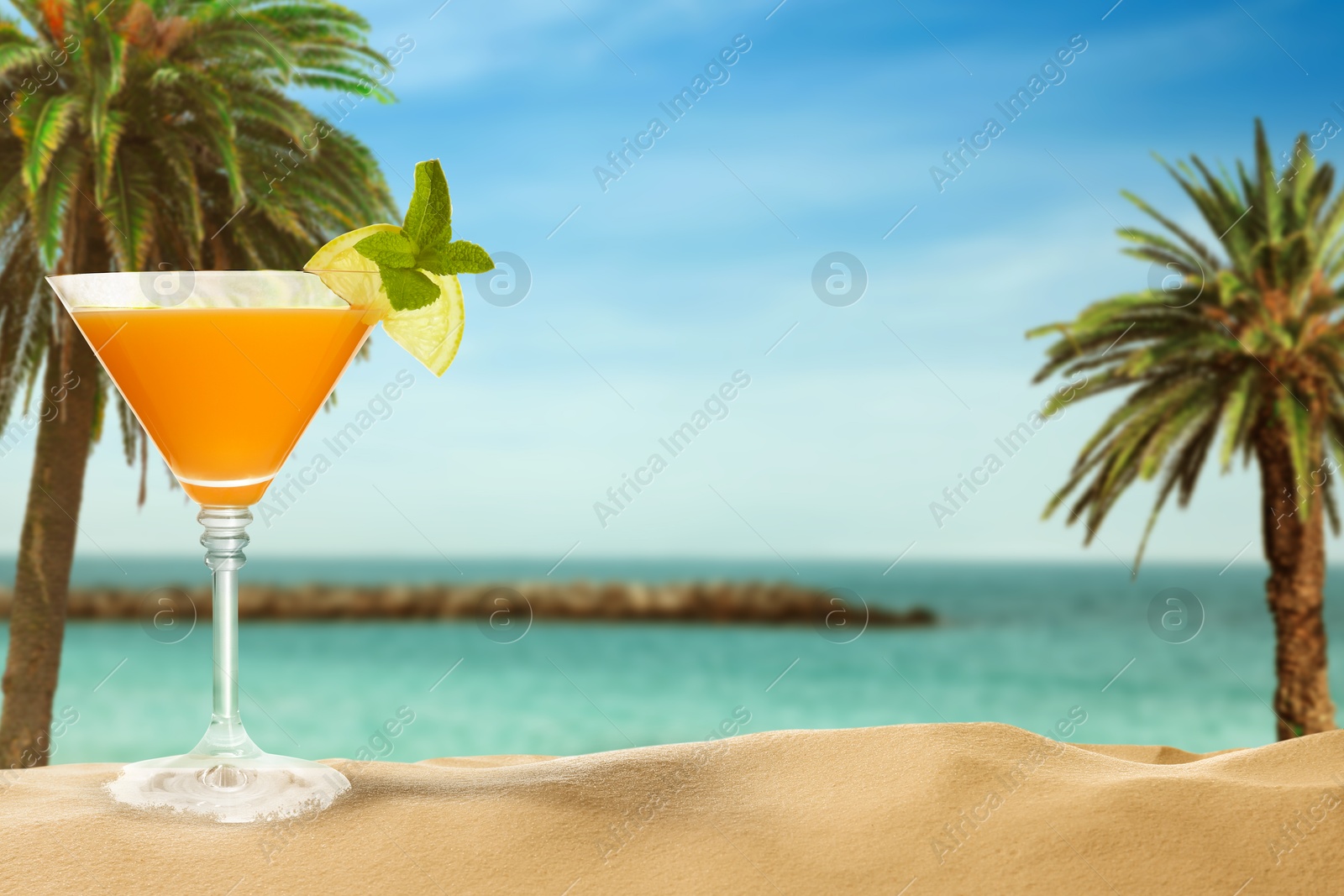 Image of Summer beach with delicious cocktail, palm trees and golden sand, space for text