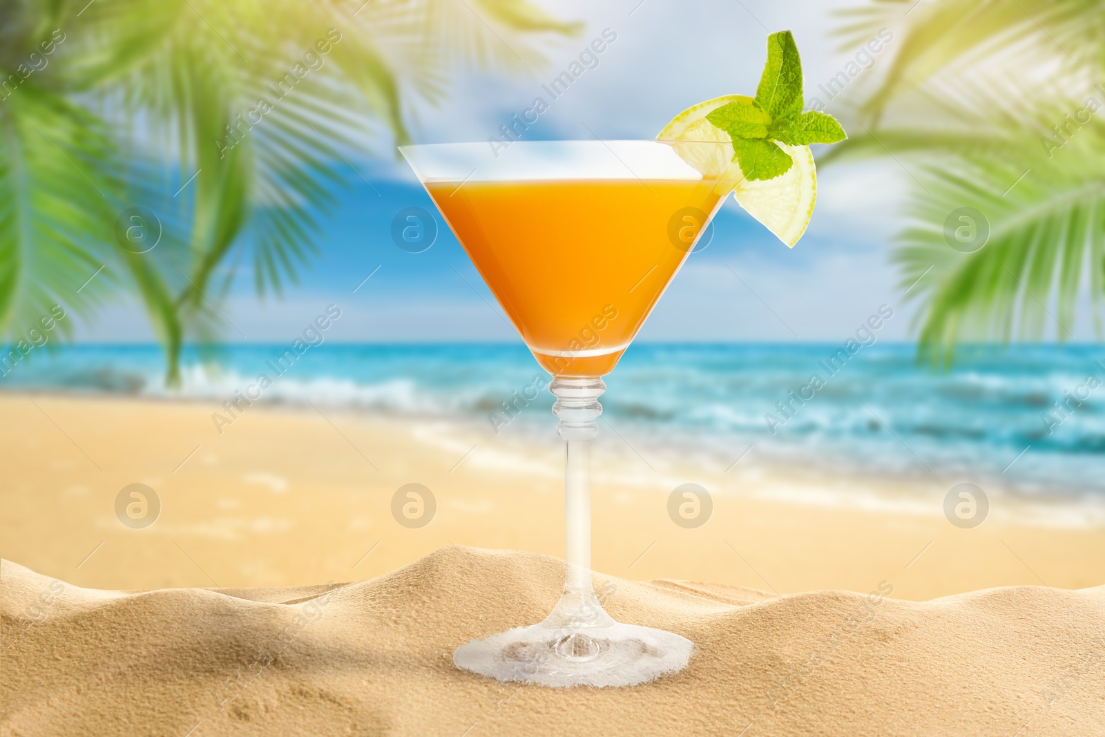 Image of Summer beach with delicious cocktail, palm leaves and golden sand