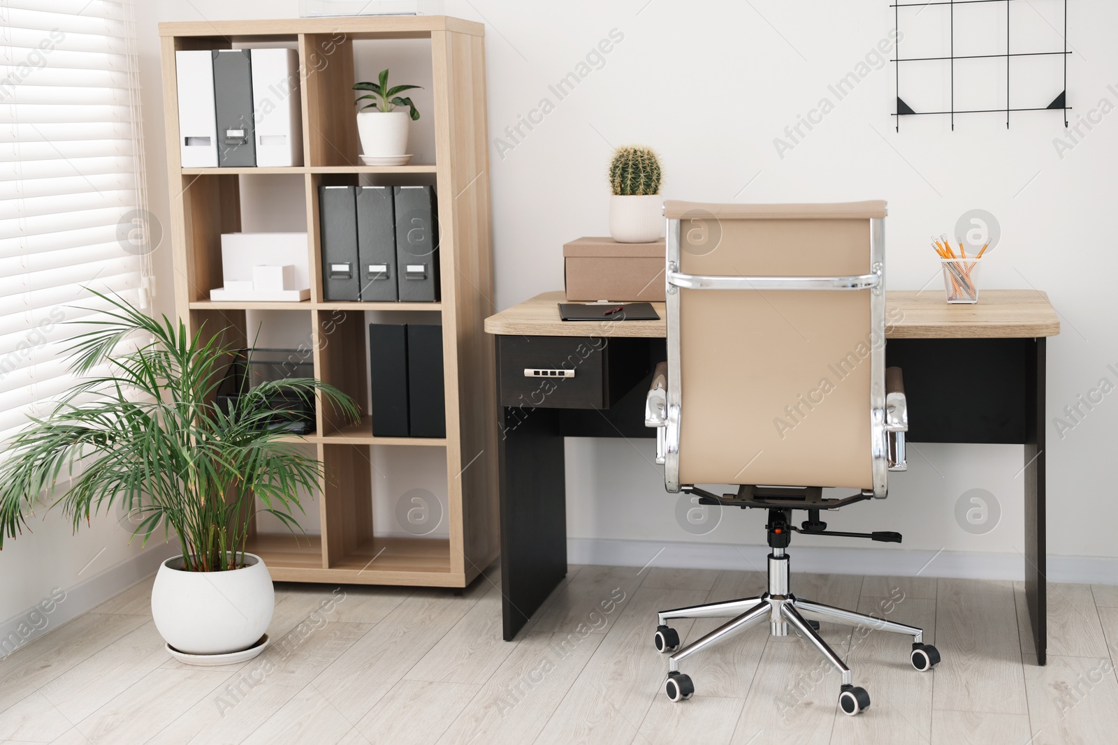 Photo of Beige leather chair and desk in office