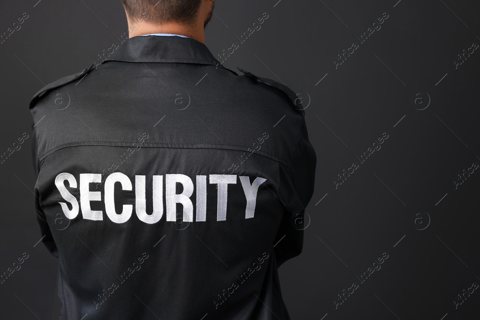 Photo of Security guard in uniform on black background, closeup