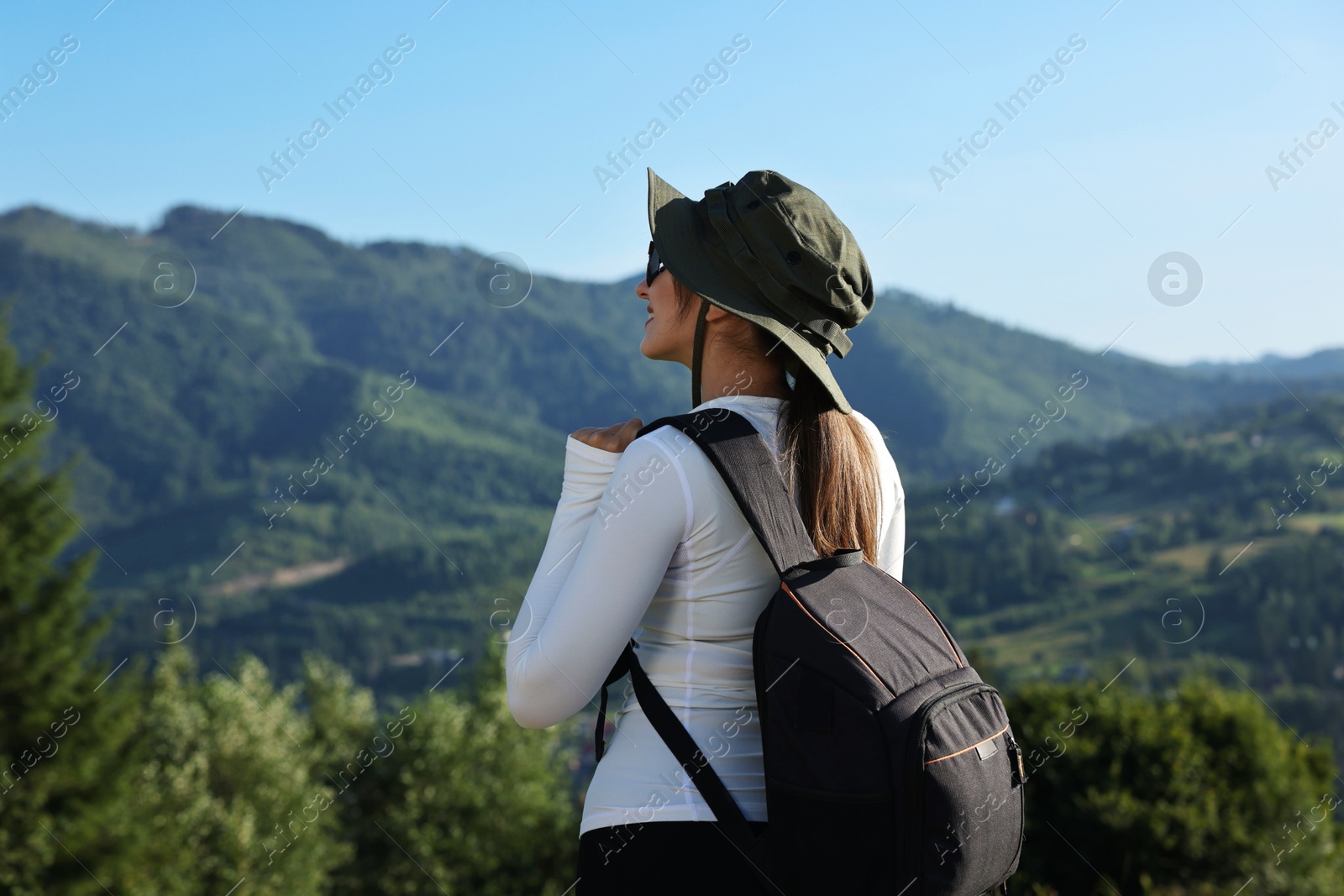 Photo of Young woman with backpack in beautiful mountains