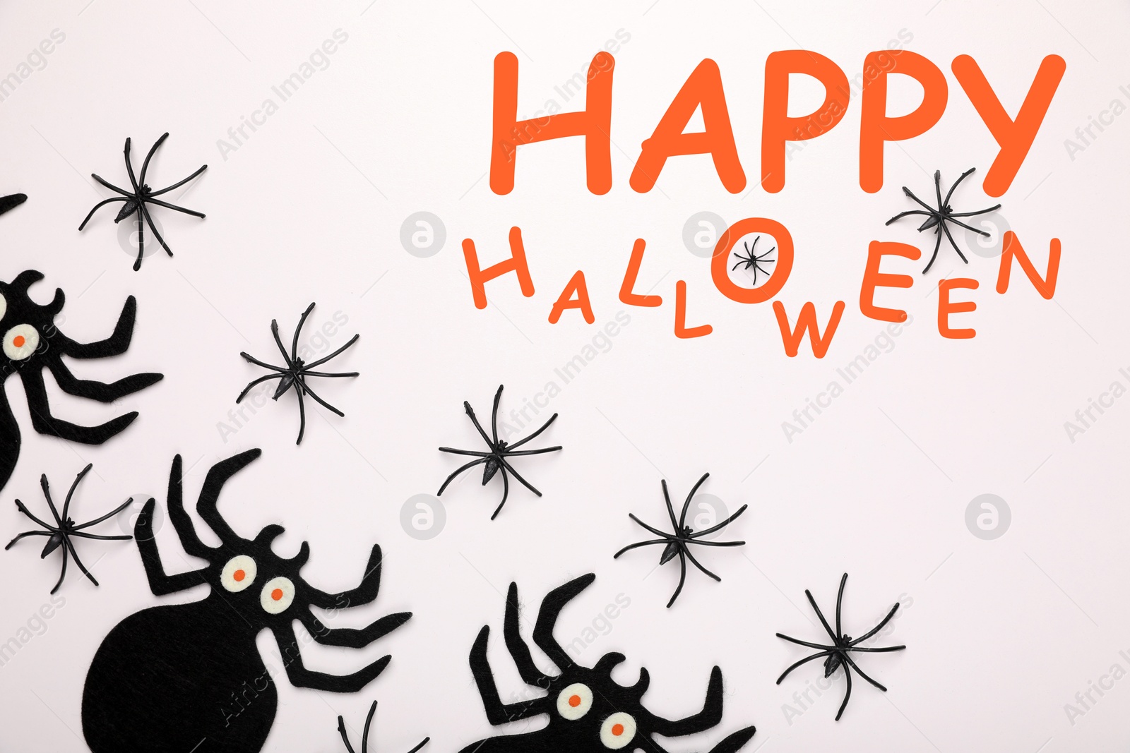 Image of Happy Halloween text and scary spiders on white background, top view. Greeting card