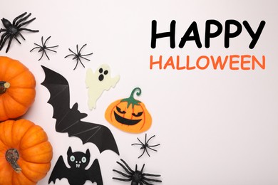 Image of Happy Halloween text and spooky decor on white background, top view. Greeting card