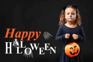 Happy Halloween card. Girl dressed like cat holding pumpkin bucket on black background