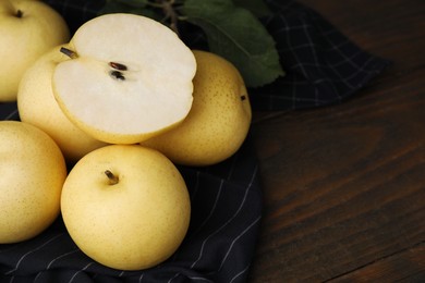 Photo of Delicious fresh apple pears on wooden table, closeup. Space for text