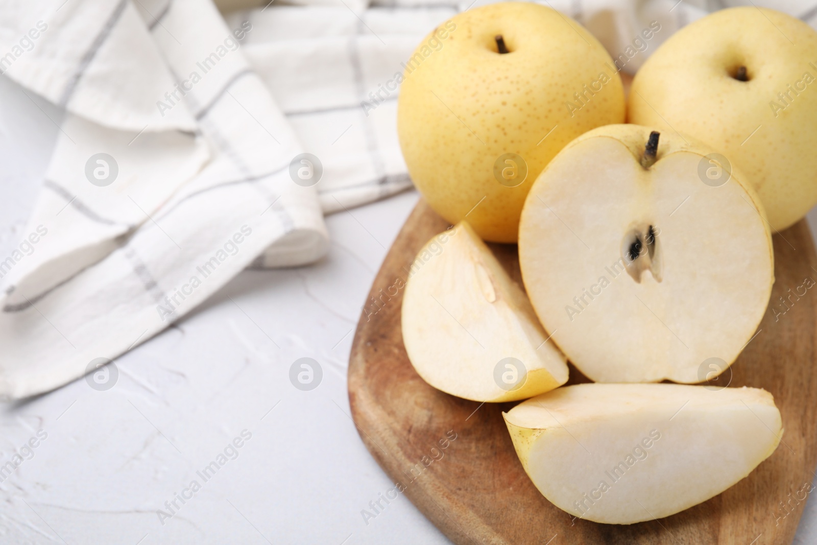 Photo of Delicious fresh apple pears on white table, closeup. Space for text