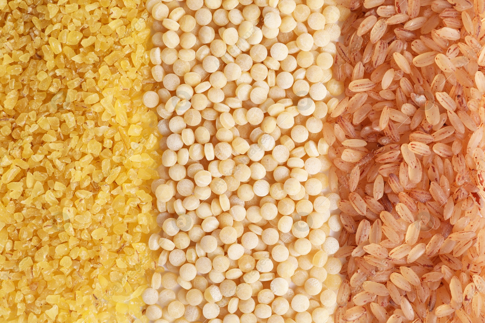 Photo of Different cereal grains as background, top view