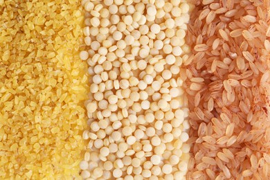 Photo of Different cereal grains as background, top view