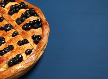 Tasty homemade pie with blueberries on blue wooden table, closeup. Space for text