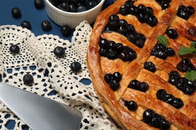 Photo of Tasty homemade pie with blueberries and mint served on table