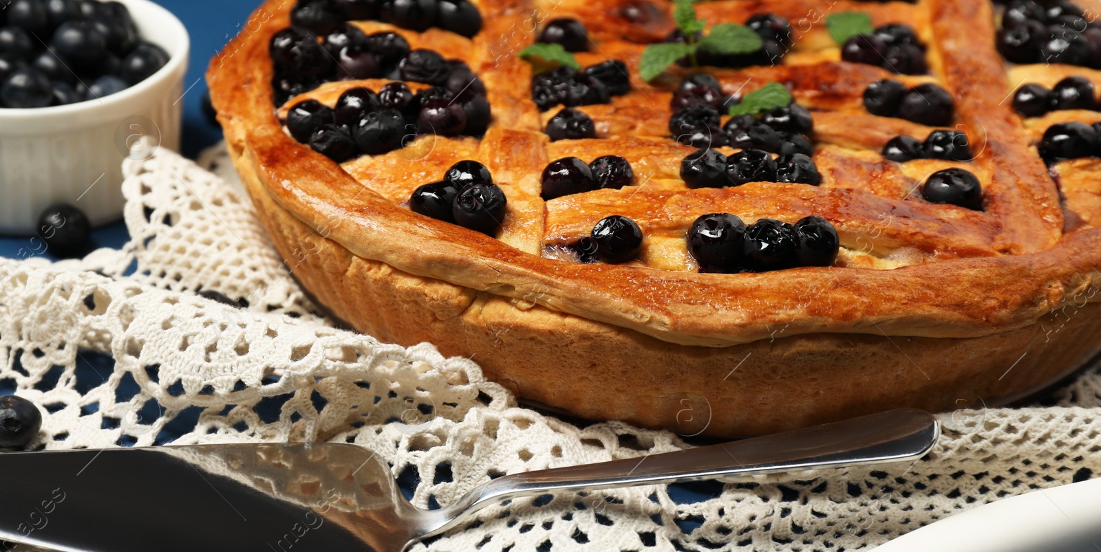 Photo of Tasty homemade pie with blueberries served on table, closeup