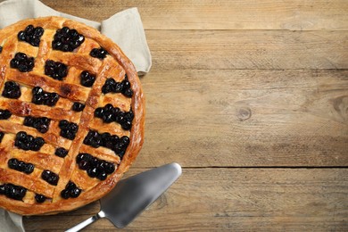 Photo of Tasty homemade pie with blueberries served on wooden table, flat lay. Space for text